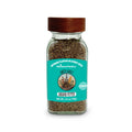 Glass jar of ground pepper with a brown lid on a white background